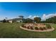 Community center with a lovely fountain and circular walkway lined with bright flowers and manicured shrubs at 801 Oakmont Ave, Sun City Center, FL 33573