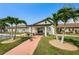 Well-maintained community library entrance surrounded by lush landscaping and palm trees, promoting a relaxing environment at 801 Oakmont Ave, Sun City Center, FL 33573