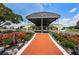 Sun City Center Community Hall entrance featuring brick pathway and professional landscaping at 801 Oakmont Ave, Sun City Center, FL 33573