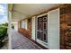 Close-up of a classic front door with white trim and a brick exterior at 801 Oakmont Ave, Sun City Center, FL 33573
