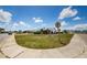 Street view showcasing a well-maintained lawn and mature landscaping on a corner lot at 801 Oakmont Ave, Sun City Center, FL 33573
