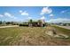 Well-maintained front yard, mature landscaping, and charming brick home under a clear sky at 801 Oakmont Ave, Sun City Center, FL 33573