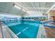Spacious indoor pool with bright blue water and a large mural to create a relaxing environment for all at 801 Oakmont Ave, Sun City Center, FL 33573