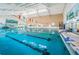 Bright indoor pool with lane dividers and colorful decorations offers an ideal space for aquatic activities and relaxation at 801 Oakmont Ave, Sun City Center, FL 33573
