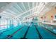 Indoor pool with clear blue water and lane dividers, creating the perfect atmosphere for fitness and recreational swimming at 801 Oakmont Ave, Sun City Center, FL 33573