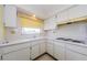 Bright kitchen featuring a sink, countertops, and range with an exhaust fan at 801 Oakmont Ave, Sun City Center, FL 33573
