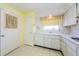 Bright kitchen featuring white cabinets, tile flooring, and a window above the sink at 801 Oakmont Ave, Sun City Center, FL 33573