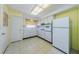 Functional kitchen featuring white appliances, ample counter space, and ceramic tile flooring at 801 Oakmont Ave, Sun City Center, FL 33573