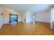 Spacious living room with light wood floors, large windows and glass enclosed porch access at 801 Oakmont Ave, Sun City Center, FL 33573