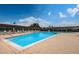 Large pool area with chairs, tables, and umbrellas for residents to enjoy the beautiful Florida weather at 801 Oakmont Ave, Sun City Center, FL 33573