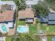 Aerial view of a home with a lush backyard, inviting pool, covered porch, and patio area at 8263 132Nd St, Seminole, FL 33776