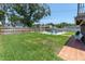 Backyard features a sparkling pool surrounded by patio pavers, lounge chairs, and a large grassy area at 8263 132Nd St, Seminole, FL 33776