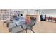 Spacious finished basement with sectional, chairs, bar, and custom shelving for a multi-use space at 8263 132Nd St, Seminole, FL 33776