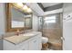 Bathroom with large mirror, granite counter, and walk-in shower at 8263 132Nd St, Seminole, FL 33776