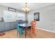 Dining area with modern chandelier, gray cabinetry and a view of the lush outdoor landscape at 8263 132Nd St, Seminole, FL 33776