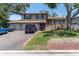 Inviting two-story home with a two-car garage, a lovely front porch, and a well-manicured front lawn at 8263 132Nd St, Seminole, FL 33776