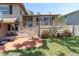Inviting front yard with a brick walkway leading to a cozy porch and well-maintained landscaping at 8263 132Nd St, Seminole, FL 33776