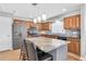 Modern kitchen features a large island with stone countertop and three pendant lights at 8263 132Nd St, Seminole, FL 33776