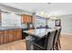 Open kitchen design with island and seating, black appliances and neutral backsplash tiles at 8263 132Nd St, Seminole, FL 33776