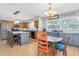 Open-concept kitchen and dining area with stylish lighting, modern decor, and views of backyard at 8263 132Nd St, Seminole, FL 33776