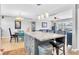 Open-concept kitchen features a granite-topped island with seating and adjacent dining and living spaces at 8263 132Nd St, Seminole, FL 33776