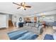 Open-concept living room with hardwood floors, a comfortable sofa, and seamless flow into the kitchen at 8263 132Nd St, Seminole, FL 33776