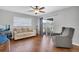 Bright living room with hardwood floors, comfortable seating, and sliding glass doors, perfect for relaxing at 8263 132Nd St, Seminole, FL 33776
