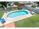 Inviting backyard pool with lush landscaping and comfortable lounge chairs, ideal for outdoor fun and relaxation at 8263 132Nd St, Seminole, FL 33776