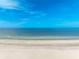 Beachfront view with clear blue waters and a sandy shore under a clear blue sky at 860 Bruce Ave, Clearwater Beach, FL 33767