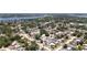 Aerial view showcasing neighborhood, homes, and nearby lake, highlighting convenient location at 9097 Southern Comfort Dr, Largo, FL 33773