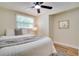Cozy bedroom featuring a ceiling fan, neutral walls, and a window with blinds at 9097 Southern Comfort Dr, Largo, FL 33773