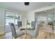 Charming dining area features modern chairs, a glass-topped table, and sliding doors to the outdoor space at 9097 Southern Comfort Dr, Largo, FL 33773