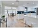 Bright, open kitchen featuring white cabinets, stainless steel appliances, and a breakfast bar with views to the dining area at 9097 Southern Comfort Dr, Largo, FL 33773