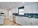 Bright kitchen with stainless steel appliances, including a dishwasher, and white cabinets at 9097 Southern Comfort Dr, Largo, FL 33773