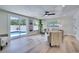 Light-filled living room featuring modern decor, recessed lighting, and a sliding glass door to the pool area at 9097 Southern Comfort Dr, Largo, FL 33773