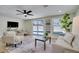 Bright and airy living room with neutral tones, recessed lighting, and a view of the outdoor pool at 9097 Southern Comfort Dr, Largo, FL 33773
