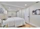 Spacious bedroom with light hardwood flooring, white walls, ensuite access, and a decorative accent at 9097 Southern Comfort Dr, Largo, FL 33773