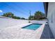 Private backyard features a sparkling in-ground pool, complemented by a paved patio area and secure fencing at 9097 Southern Comfort Dr, Largo, FL 33773