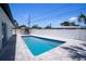 Backyard pool area featuring a storage shed, ample patio space, and a privacy fence at 9097 Southern Comfort Dr, Largo, FL 33773