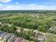 A panoramic view of the landscape, showcasing the property's location amidst trees and clear skies at 9307 Golf View Dr, New Port Richey, FL 34655