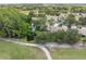 Beautiful aerial view of a well-manicured golf course, water features, and surrounding community homes at 9307 Golf View Dr, New Port Richey, FL 34655