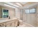 Bathroom featuring a glass shower and vanity with marble countertops and tile floors at 9307 Golf View Dr, New Port Richey, FL 34655