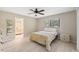 Bright bedroom with ceiling fan, light wood floors, and natural light from the window at 9307 Golf View Dr, New Port Richey, FL 34655