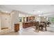 Open concept kitchen and dining room with hardwood floors and lots of natural light at 9307 Golf View Dr, New Port Richey, FL 34655