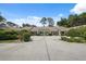 Property featuring large driveway with well maintained lawn and shrubbery at 9307 Golf View Dr, New Port Richey, FL 34655