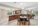 Open-concept kitchen and dining area with granite countertops and stainless steel appliances at 9307 Golf View Dr, New Port Richey, FL 34655