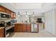 Modern kitchen features stainless steel appliances, granite countertops, and ample cabinet space at 9307 Golf View Dr, New Port Richey, FL 34655