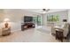 Comfortable living room with a ceiling fan, sliding glass doors to the porch, and great natural light at 9307 Golf View Dr, New Port Richey, FL 34655