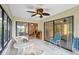Bright sunroom with large windows and sliding glass doors offers a relaxing space with scenic views at 9307 Golf View Dr, New Port Richey, FL 34655