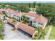 Aerial view of the condo complex, showcasing well-maintained buildings, carports, and lush landscaping at 10356 Carrollwood Ln # 204, Tampa, FL 33618